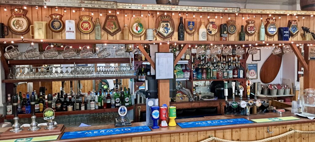 Nautical decorations over the bar front with wooden panelling